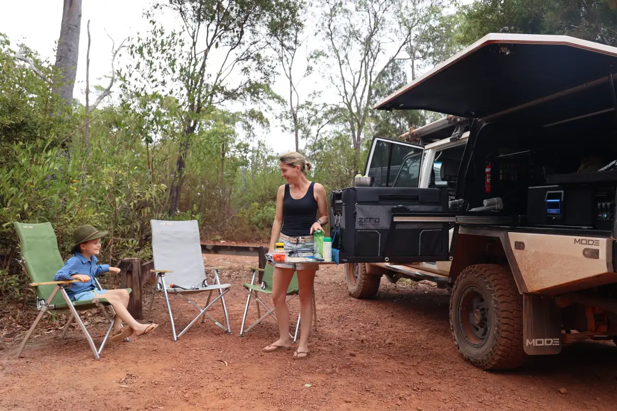 A mother and son cooking out the back of a Toyota LandCruiser in Australia