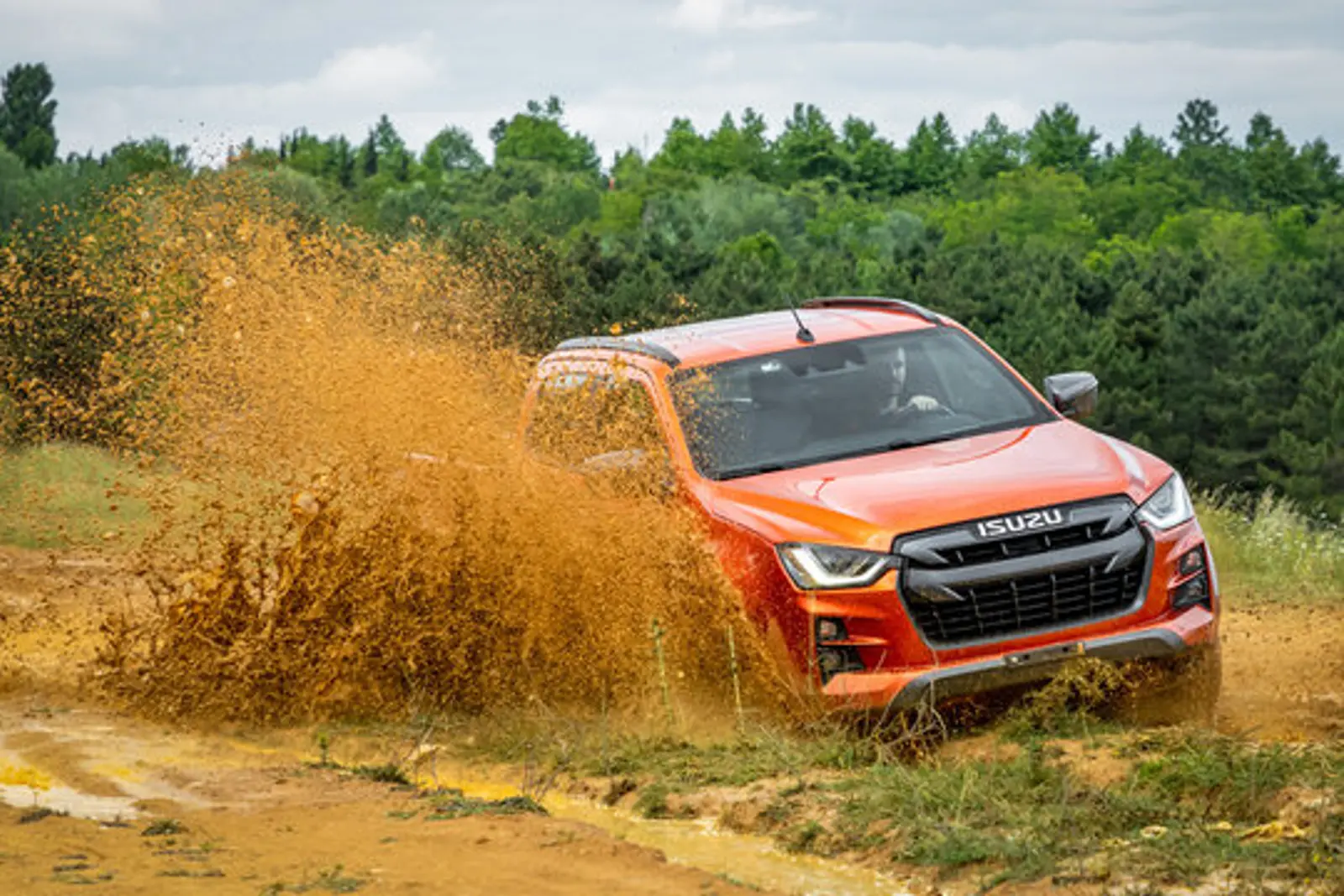 Isuzu D-Max driving through mud