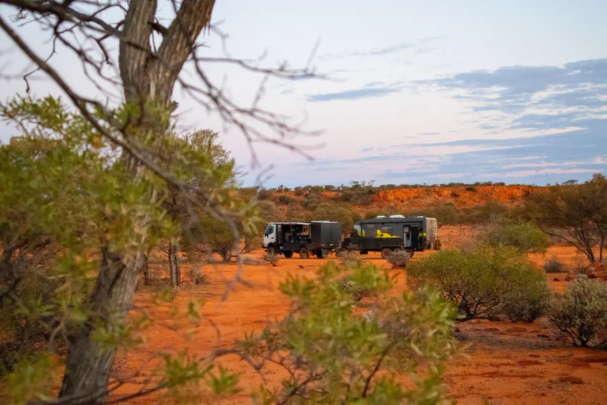 4x4 and caravan pictured in the outback with red dust