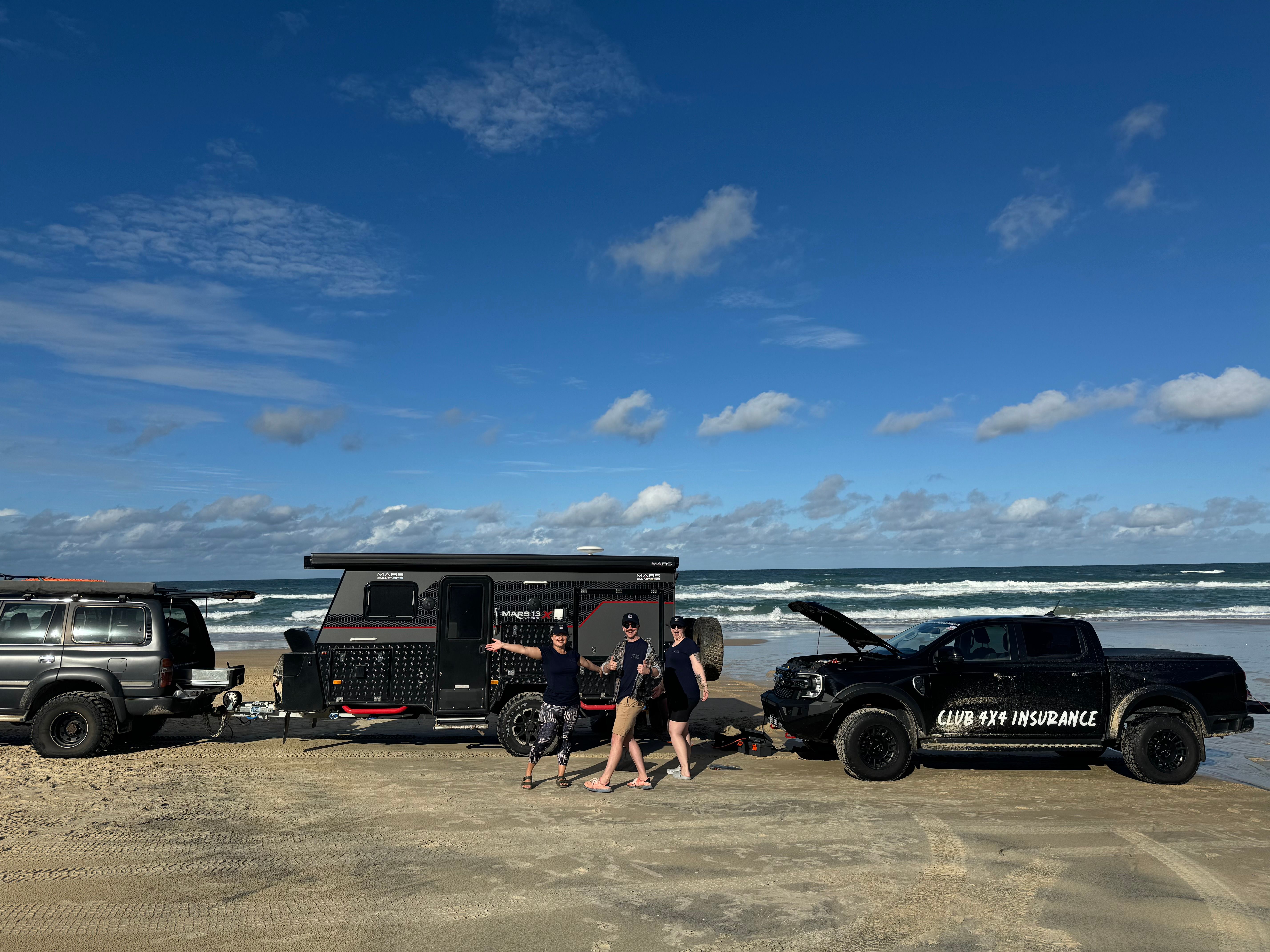 Club 4X4 branded Ford Ranger helping a bogged caravan on K'Gari