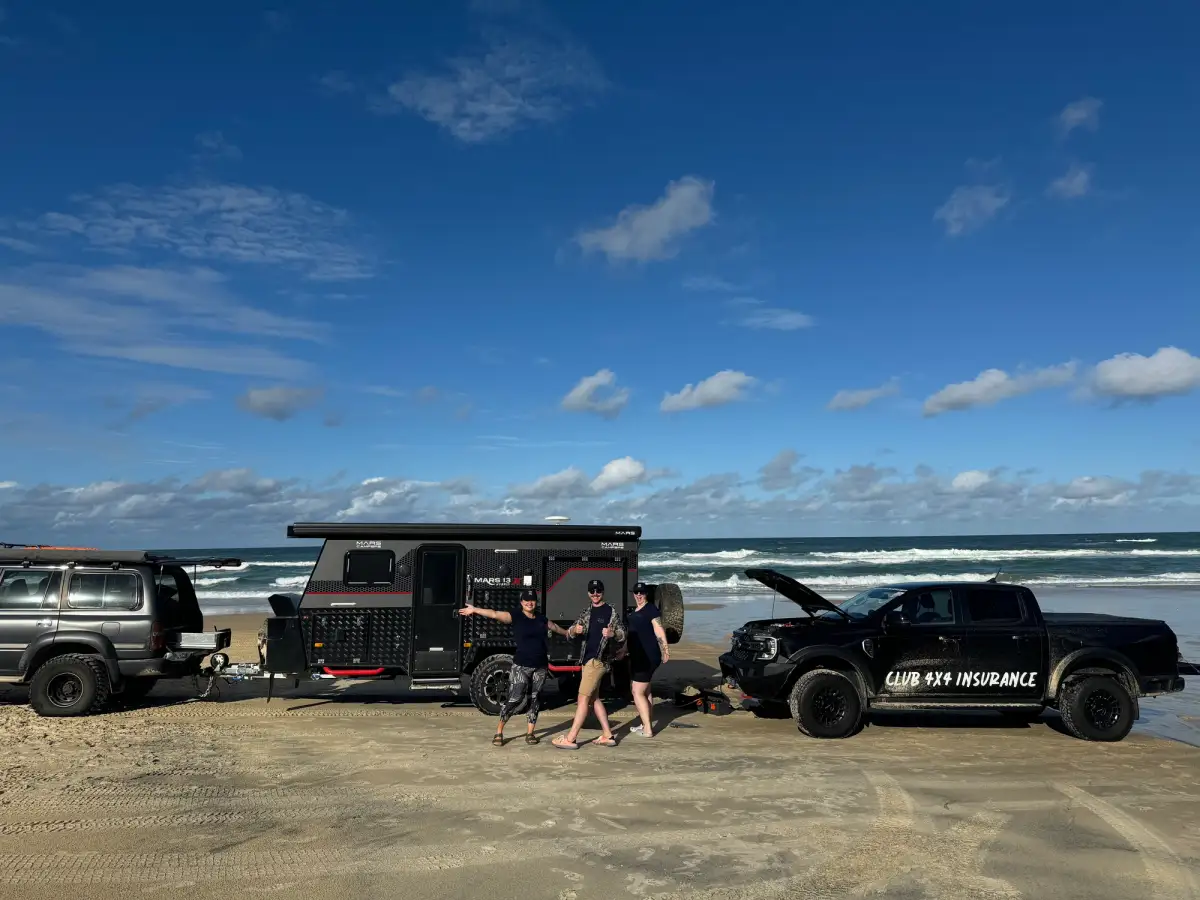 Club 4X4 branded Ford Ranger helping a bogged caravan on K'Gari