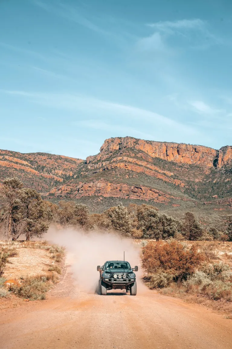 4wd driving through a dusty track in the outback