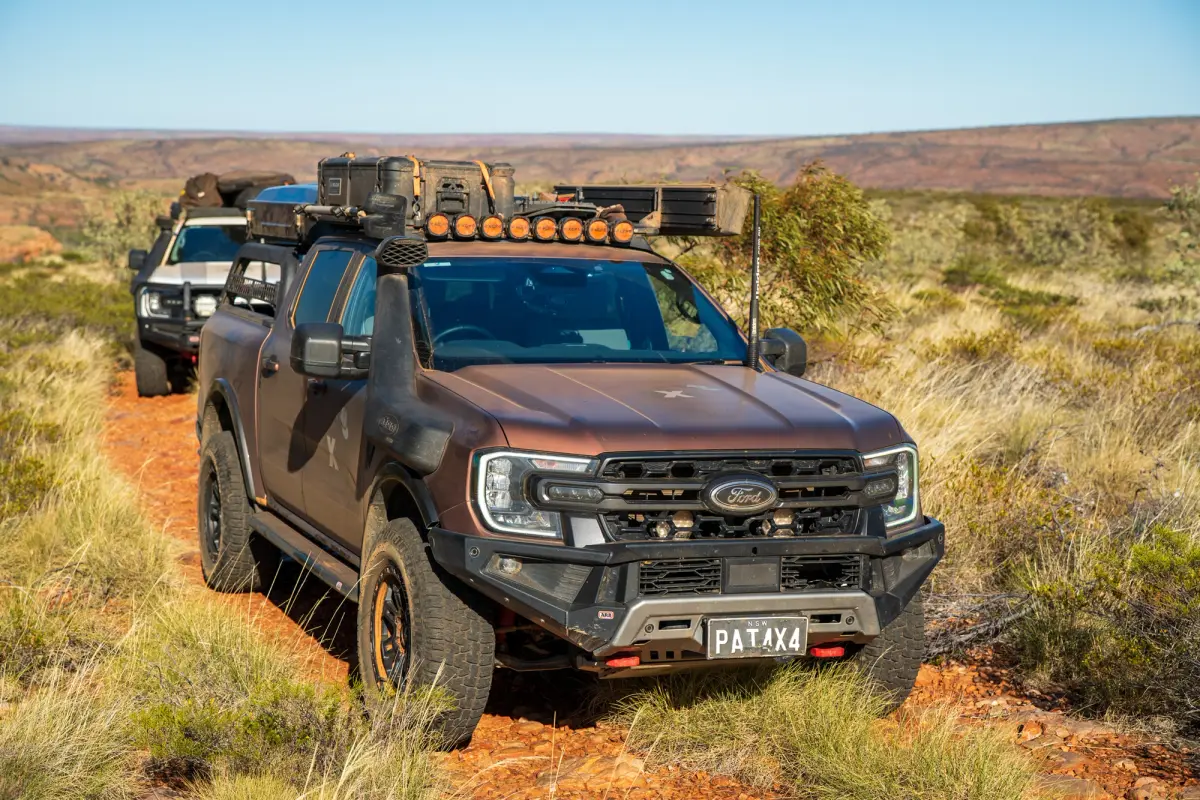 2 4X4s driving on a dirt track in the outback