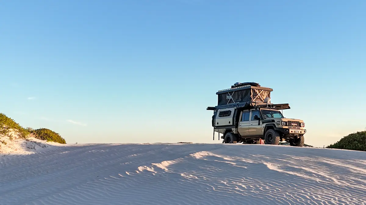 Toyota Landcruiser on top of sand dune