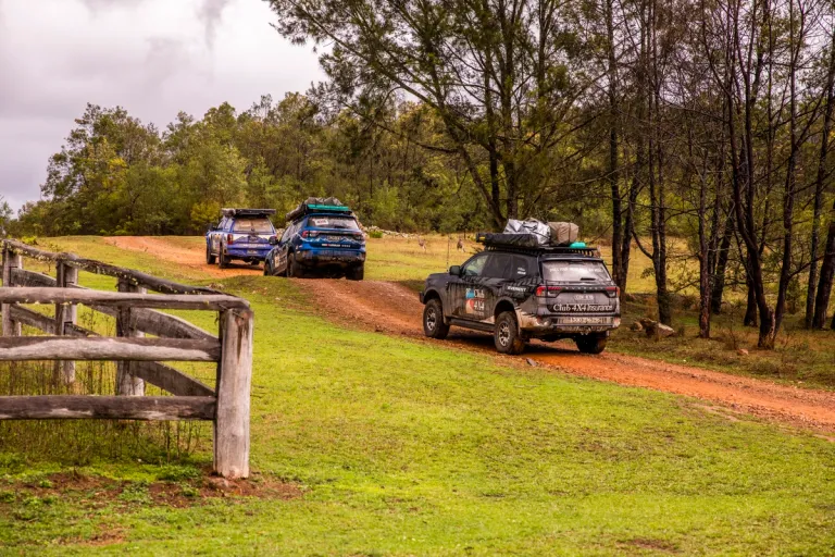 a convoy of 4wds driving on a track