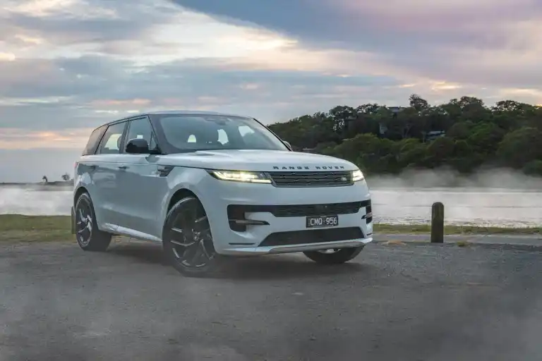 luxury white 4x4 in front of lake