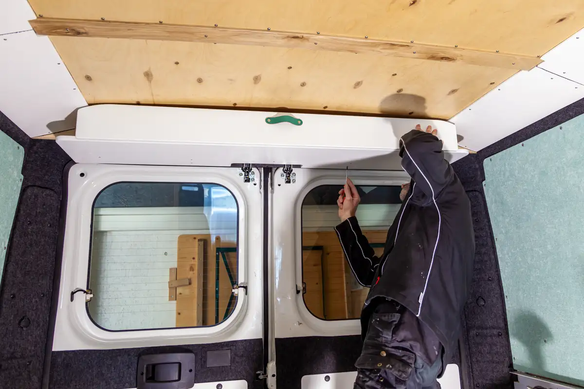 A man renovating a van into a campervan