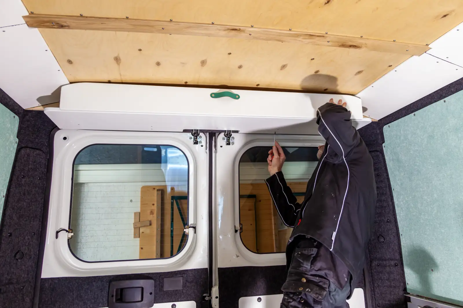 A man renovating a van into a campervan