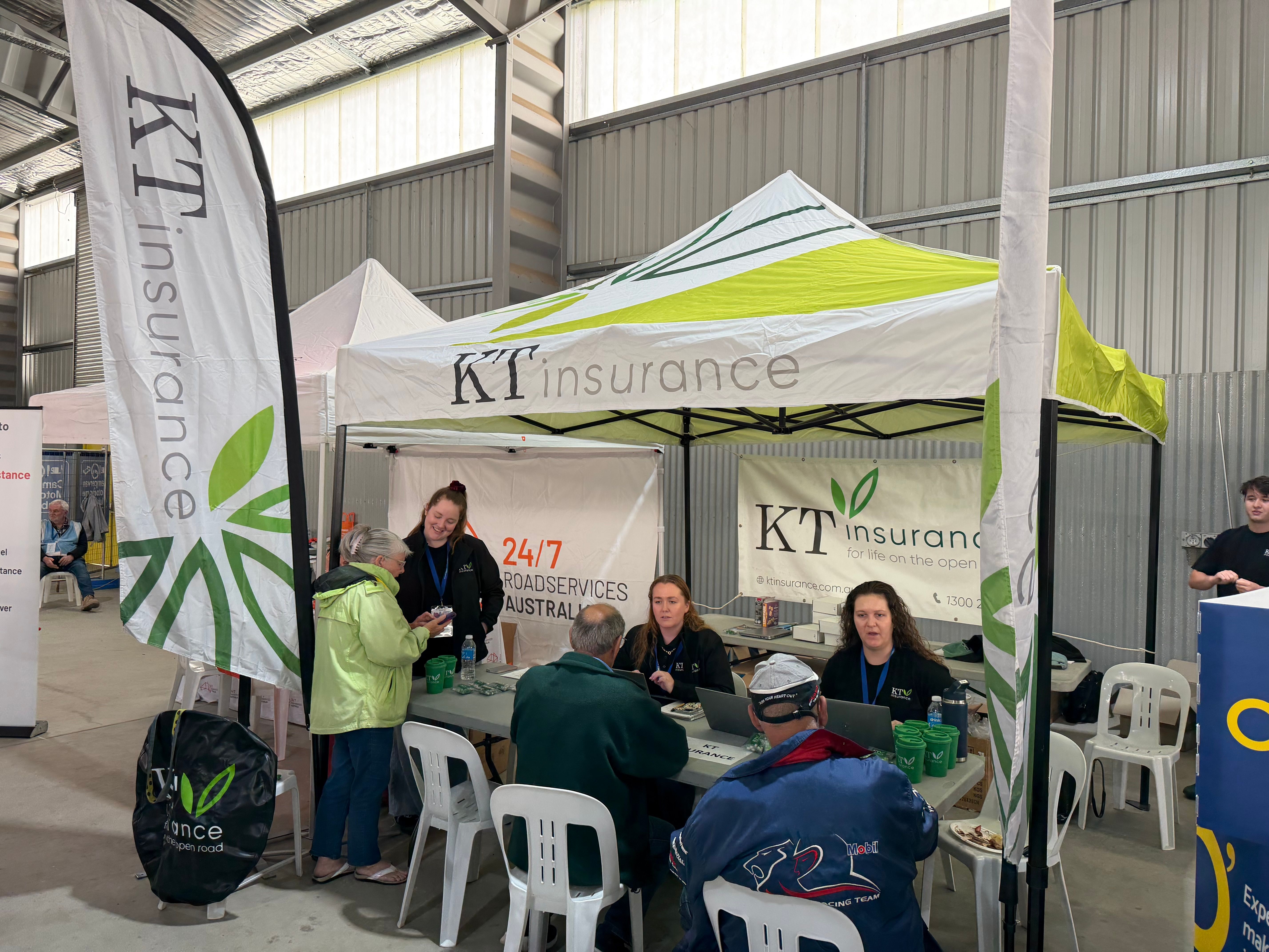 people at a stall chatting