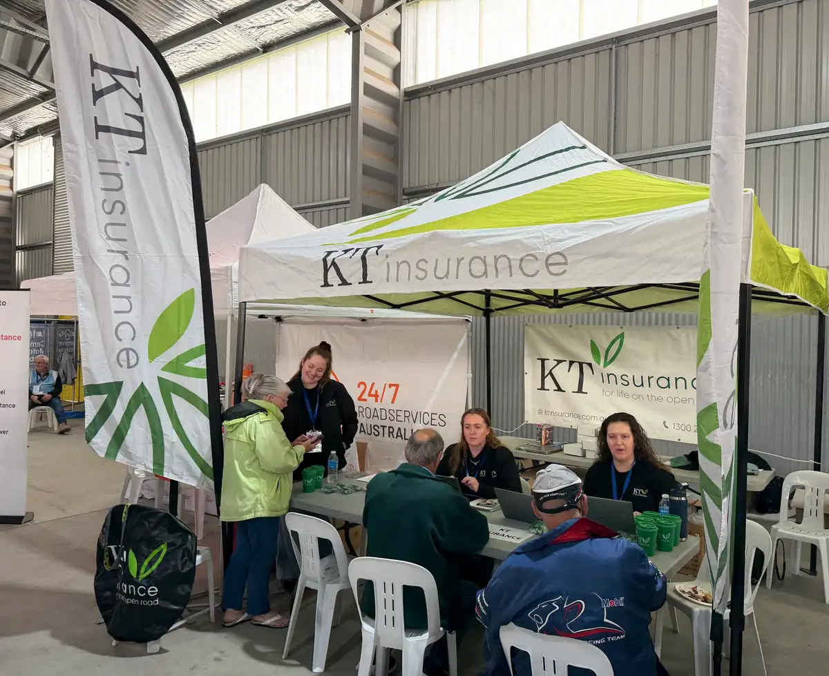 people at a stall chatting