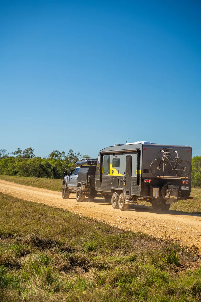 caravan travelling on outback dirt road