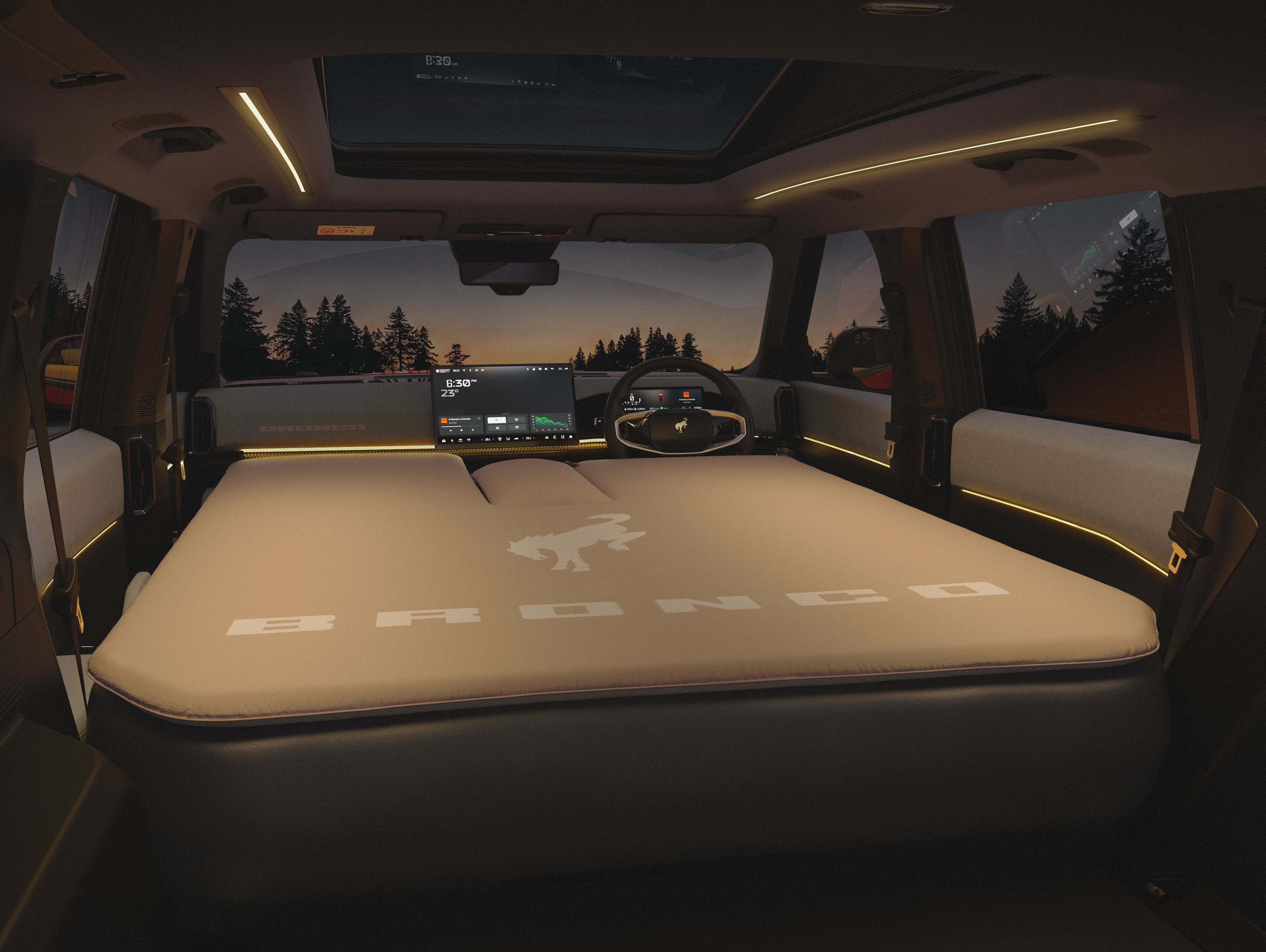 The interior of a 2027 Ford Bronco Basecamp with the seats folded down and a Bronco air mattress installed