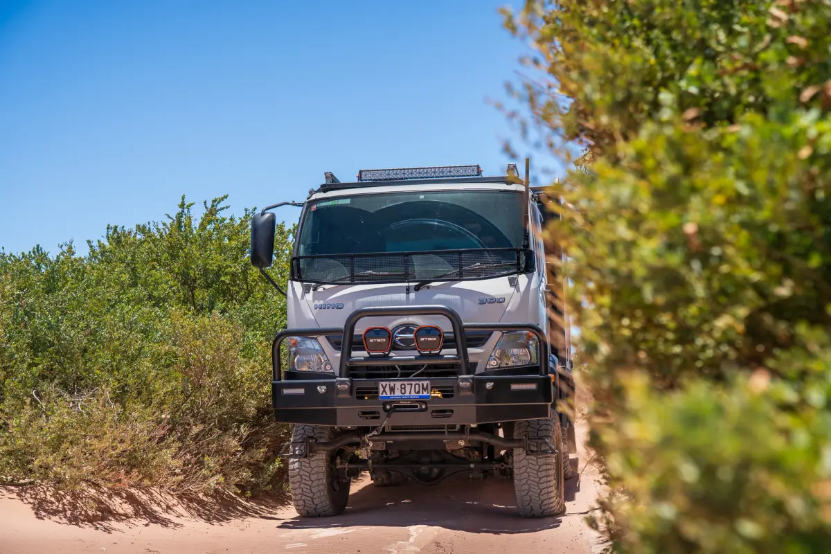 4X4 Hino 300 driving through sandy track