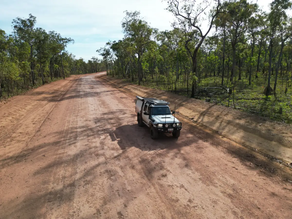 A white Toyota LandCruiser 4X4 driving on a dirt road in Australia
