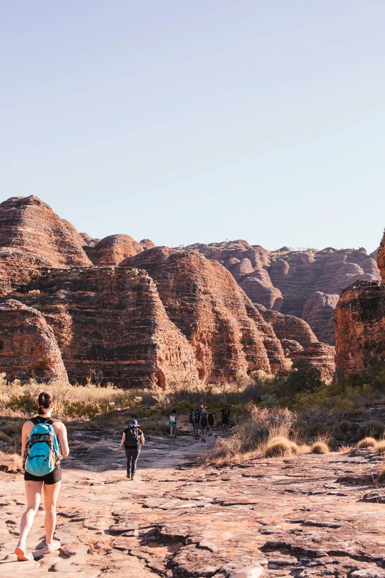 people walking into an outback mountain range