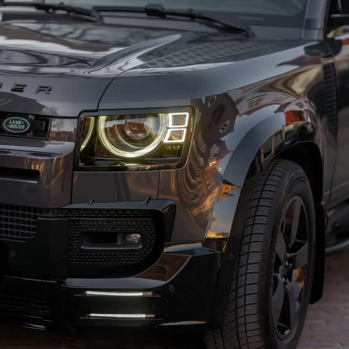 Land Rover Defender with headlights on dim