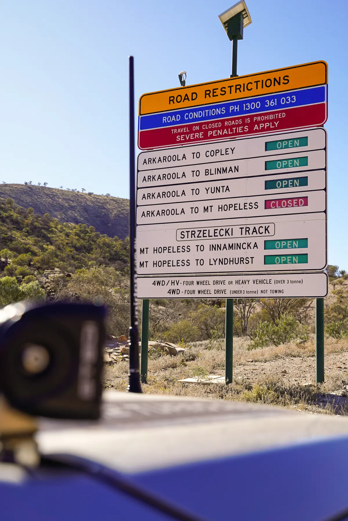 road sign showing road statuses