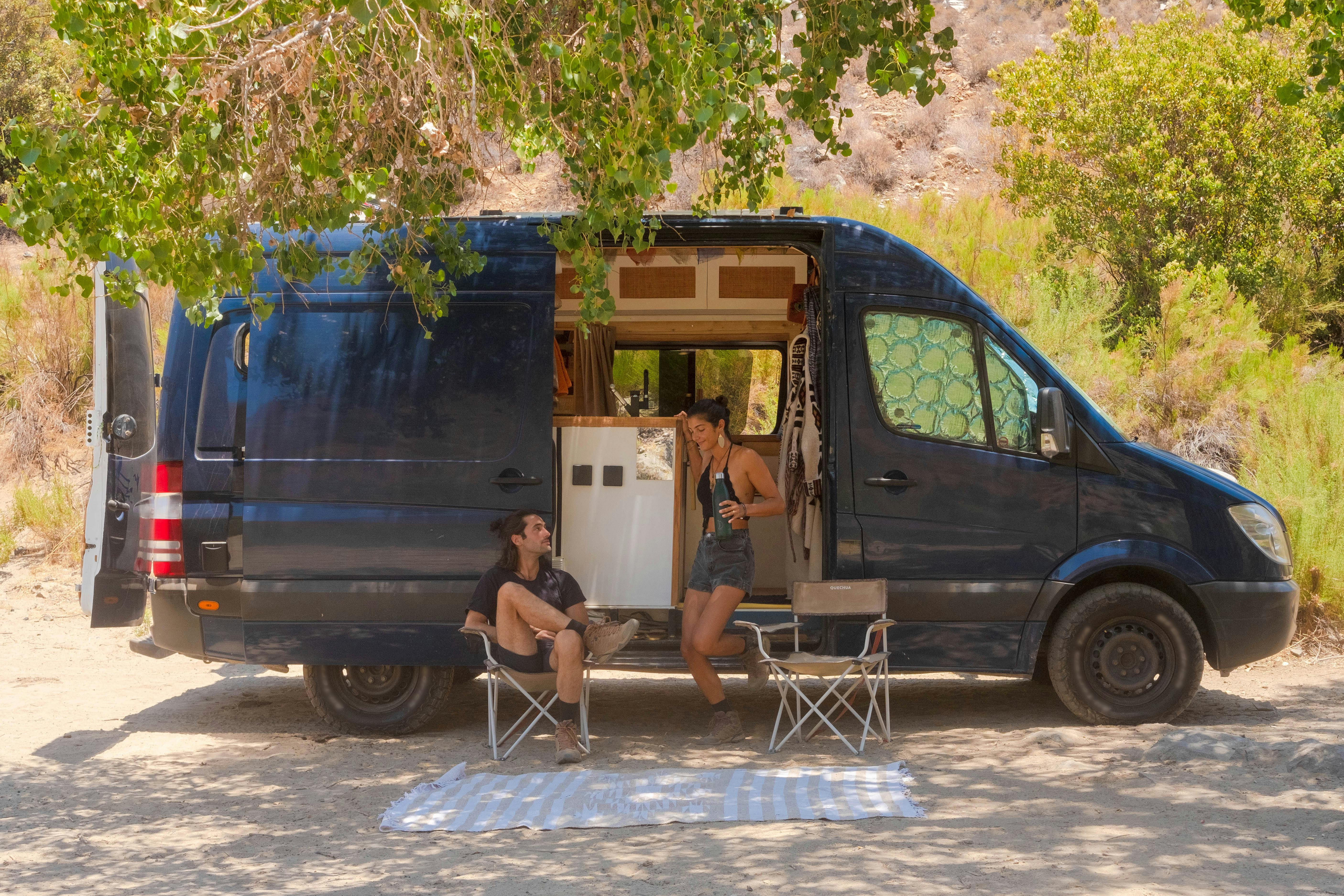 2 people camping in a campervan