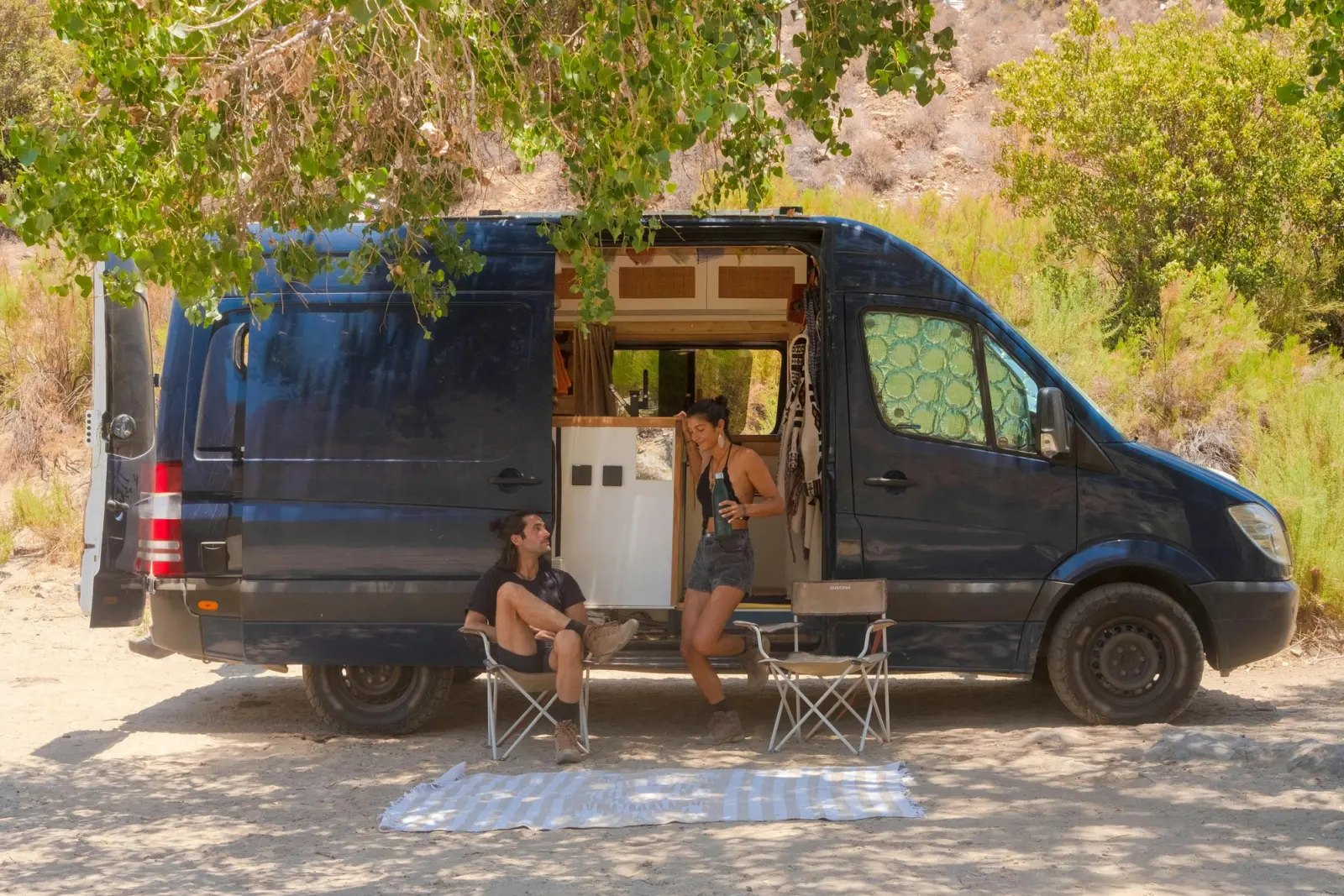 2 people camping in a campervan