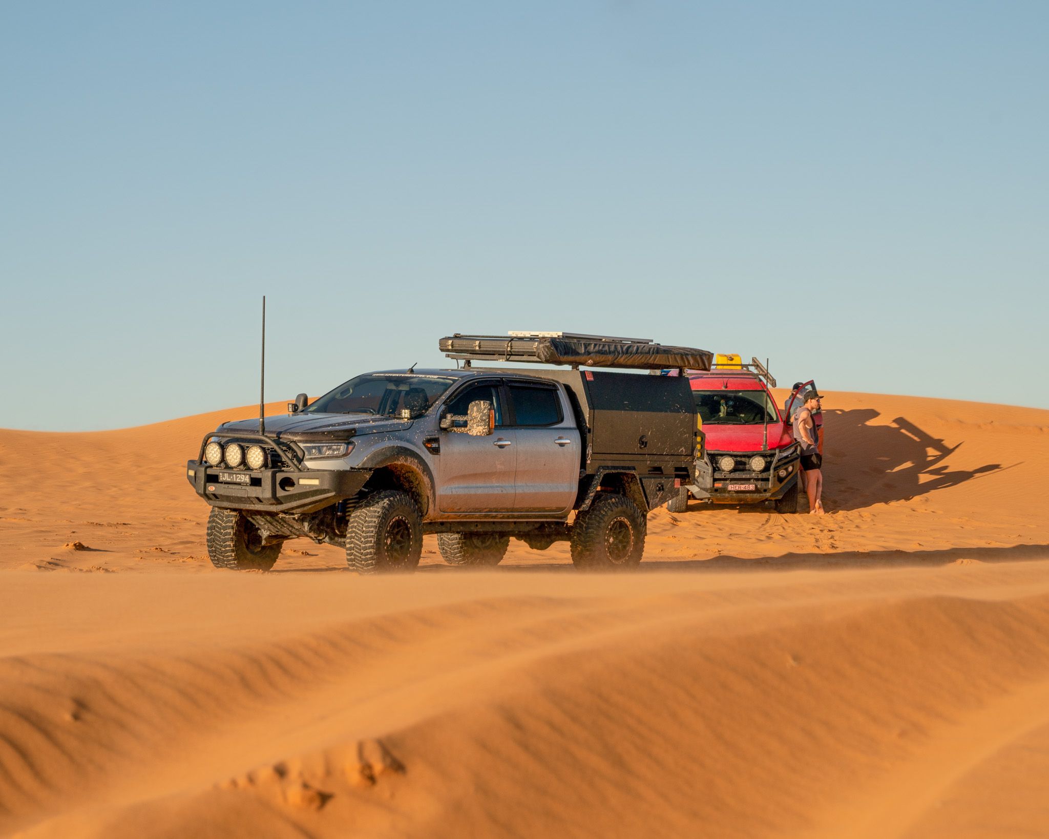 two 4x4 utes in a desert in Australia