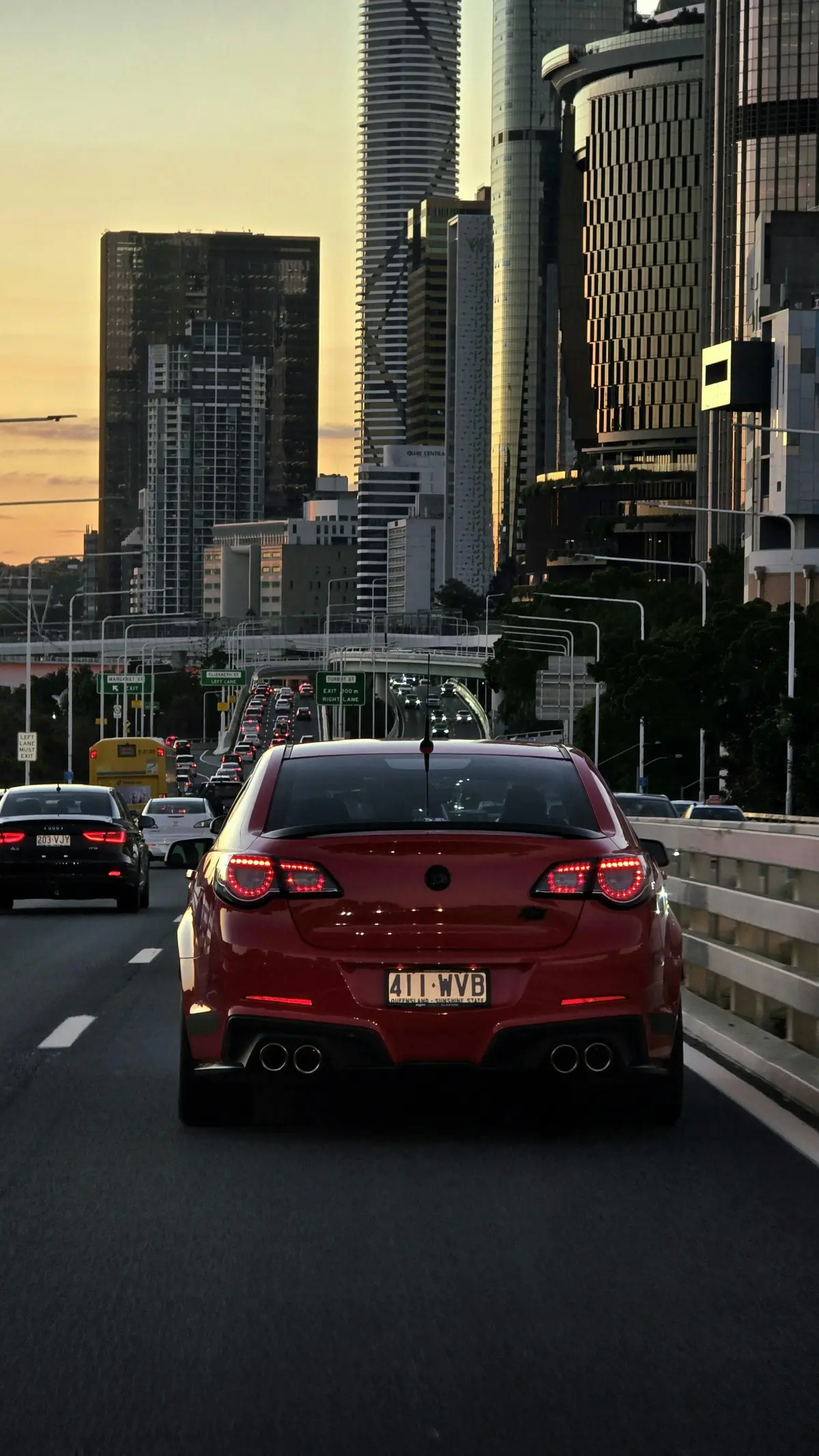 red Holden Commodore driving through Brisbane City