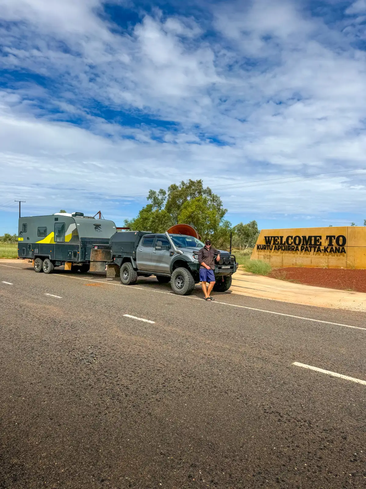 4x4 towing caravan in rural town