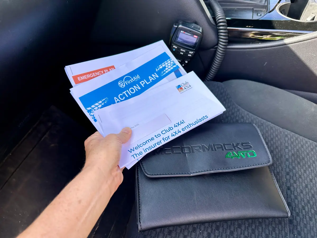 someone holding documents inside a car