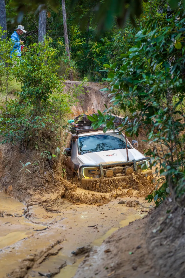 4x4 driving through a gulley filled with mud