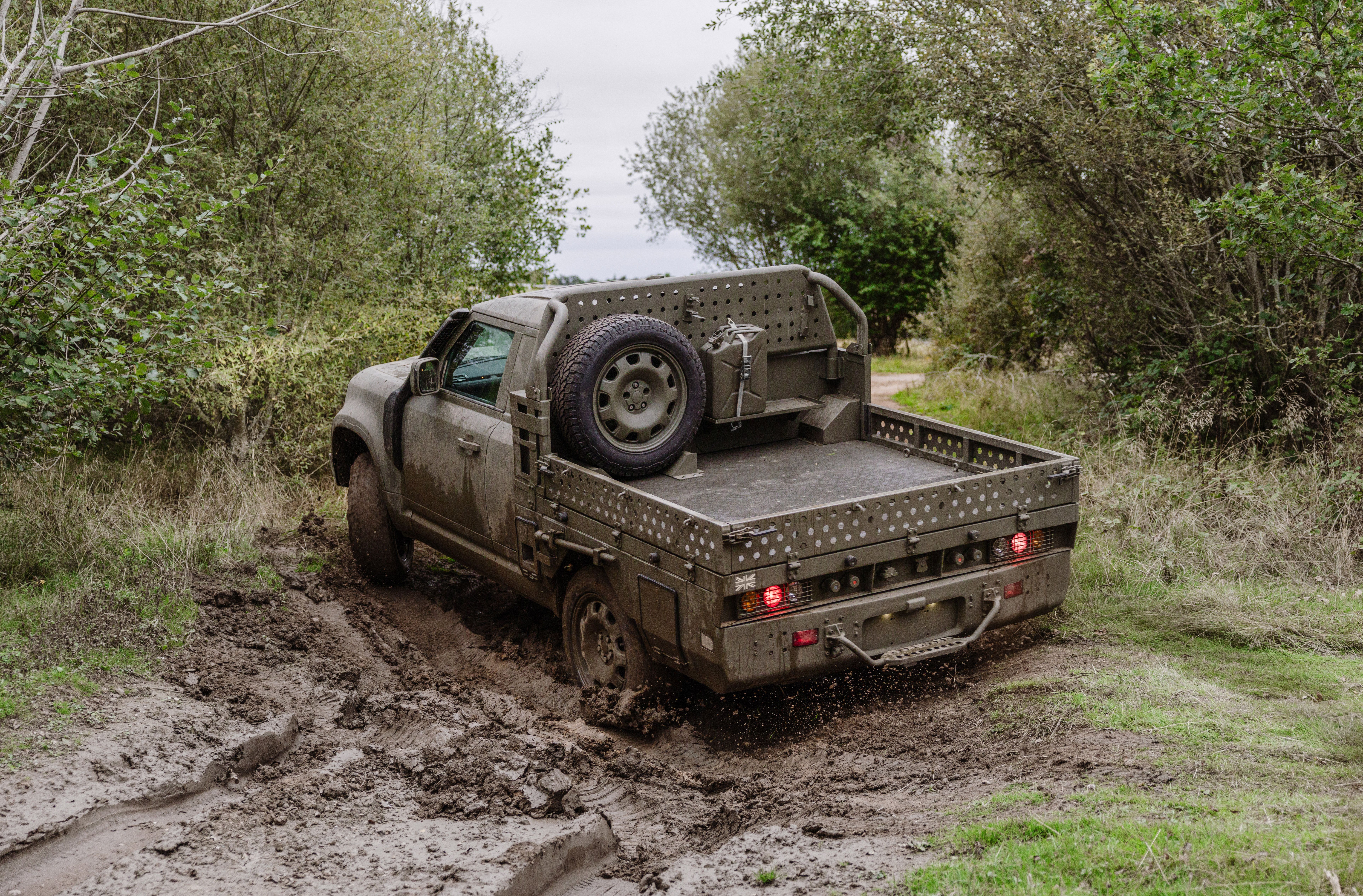 A Land Rover Defender Wolf Series II being driven through mud in the UK