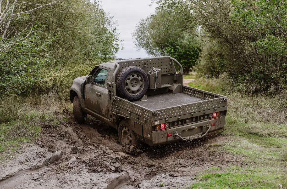 A Land Rover Defender Wolf Series II being driven through mud in the UK