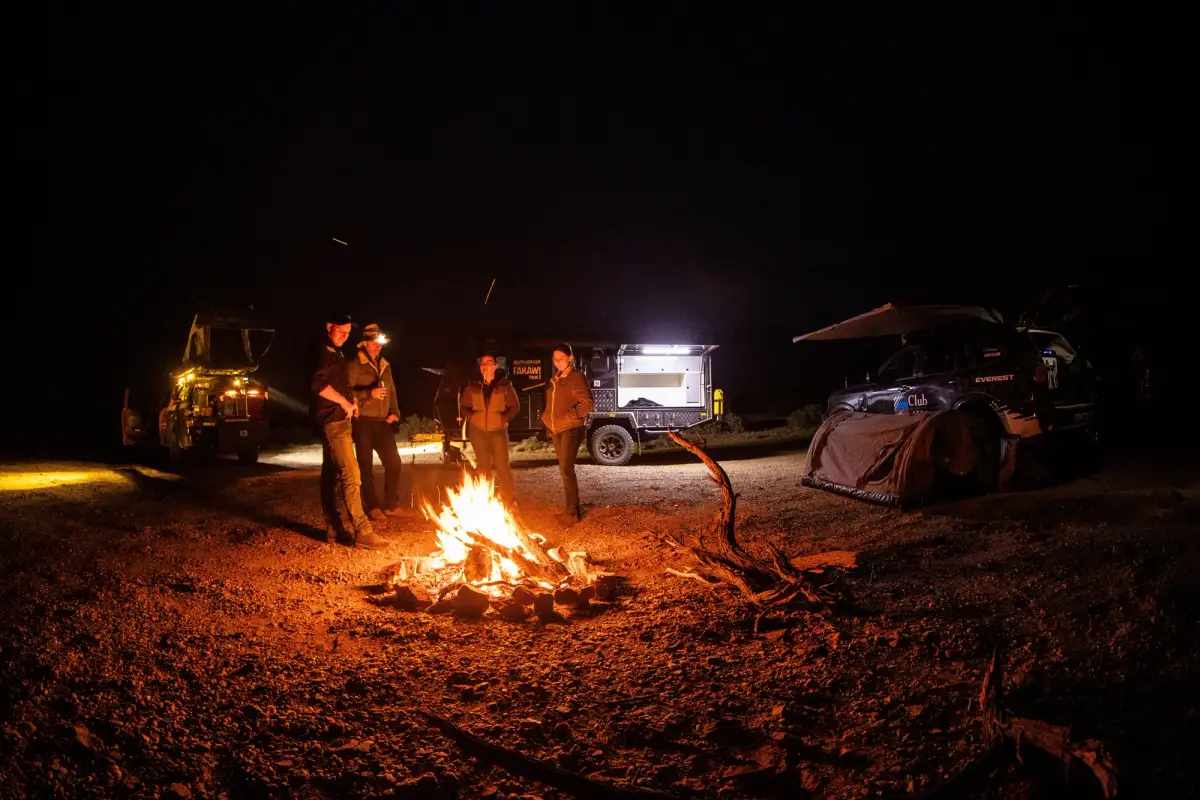 group around a campfire outback australia