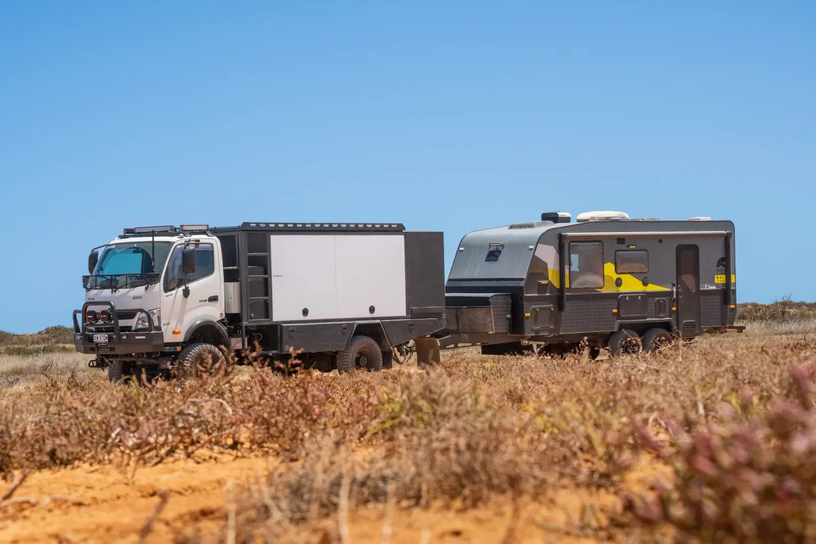 A 4X4 light truck towing a caravan in Australia's Outback