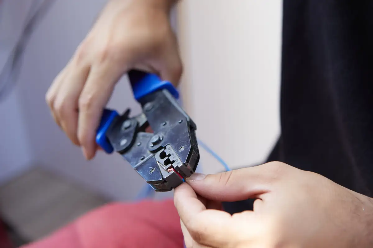 A crimping tool being used on a cable