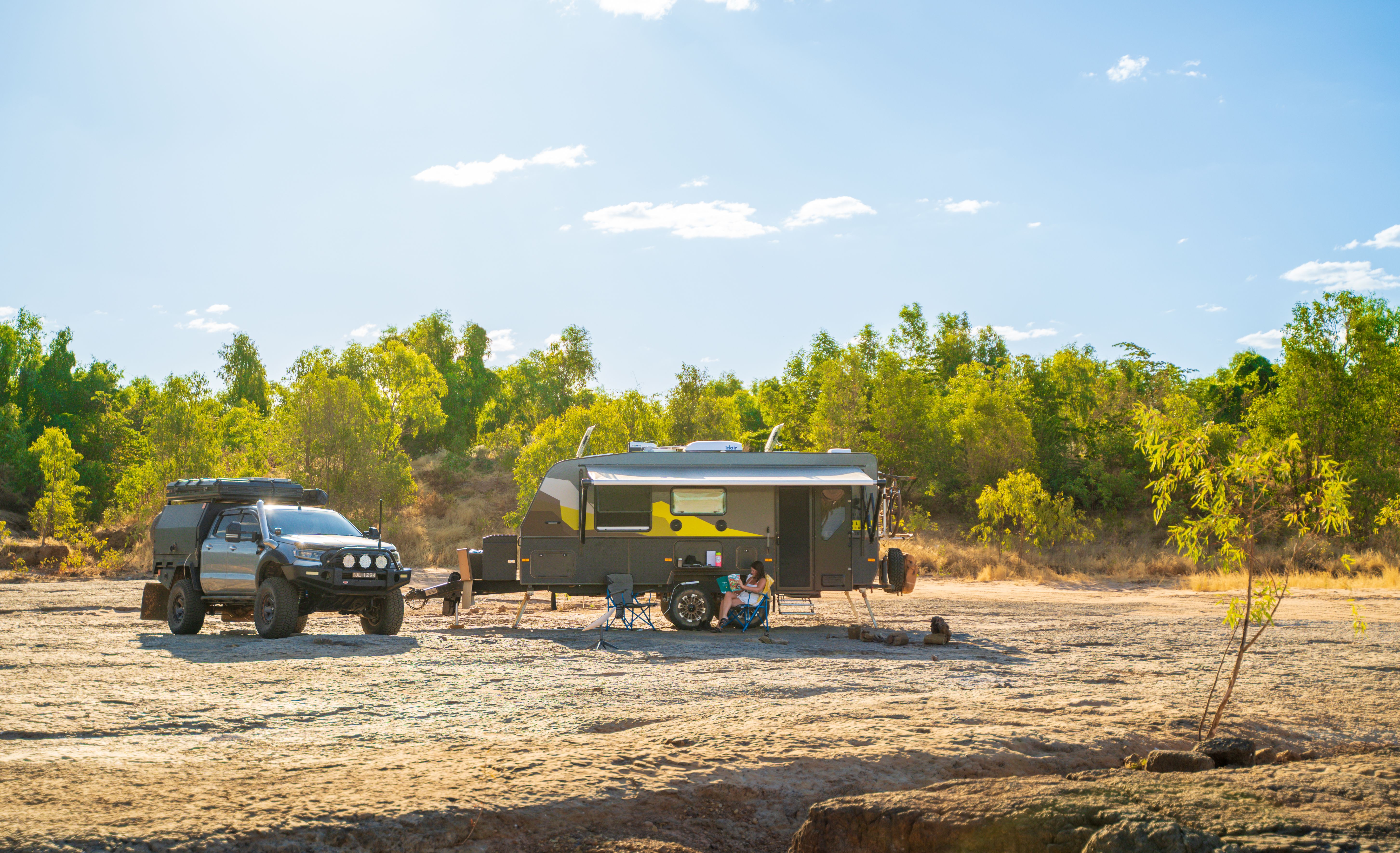 4wd and caravan in distance in a field