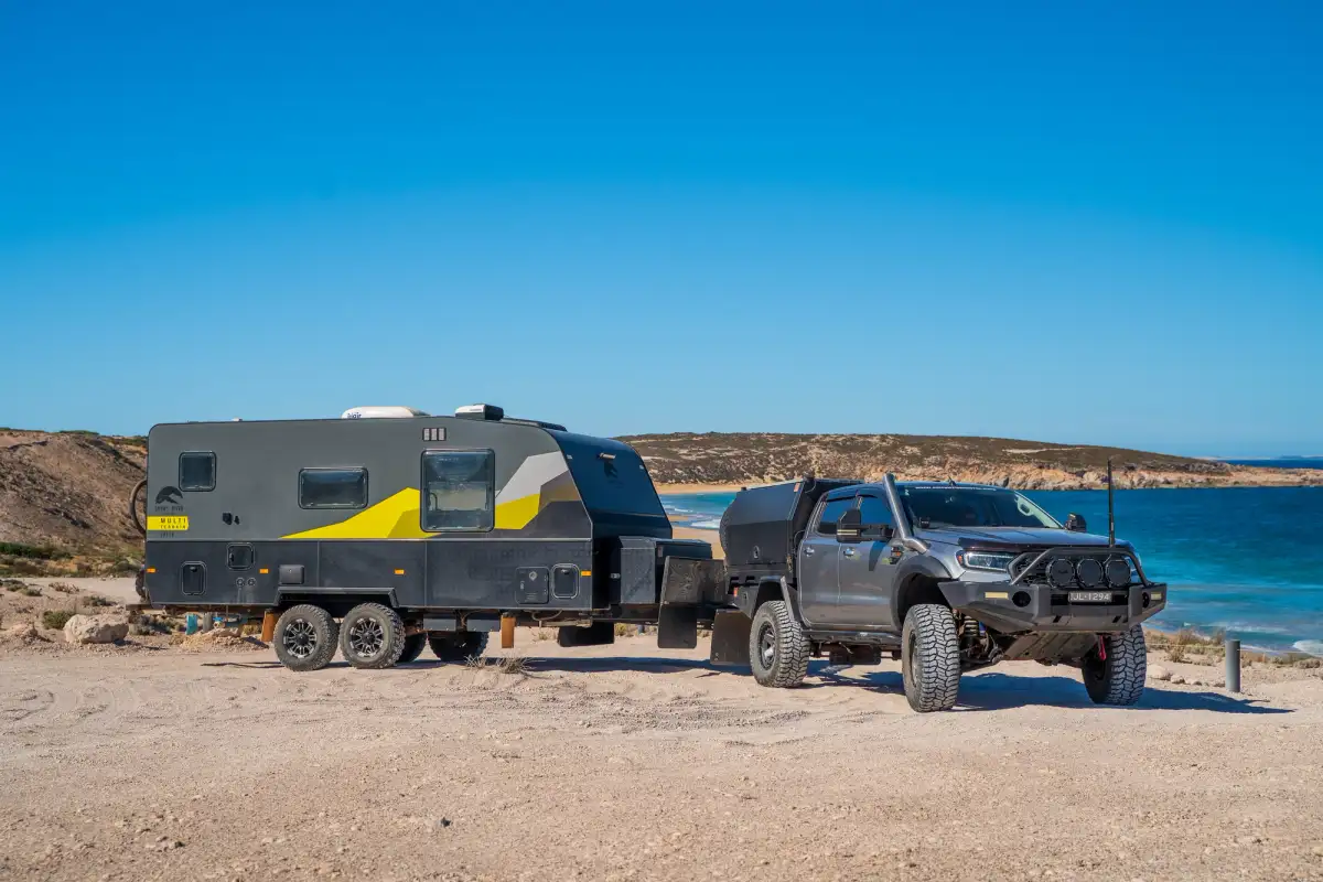 4x4 towing caravan near ocean