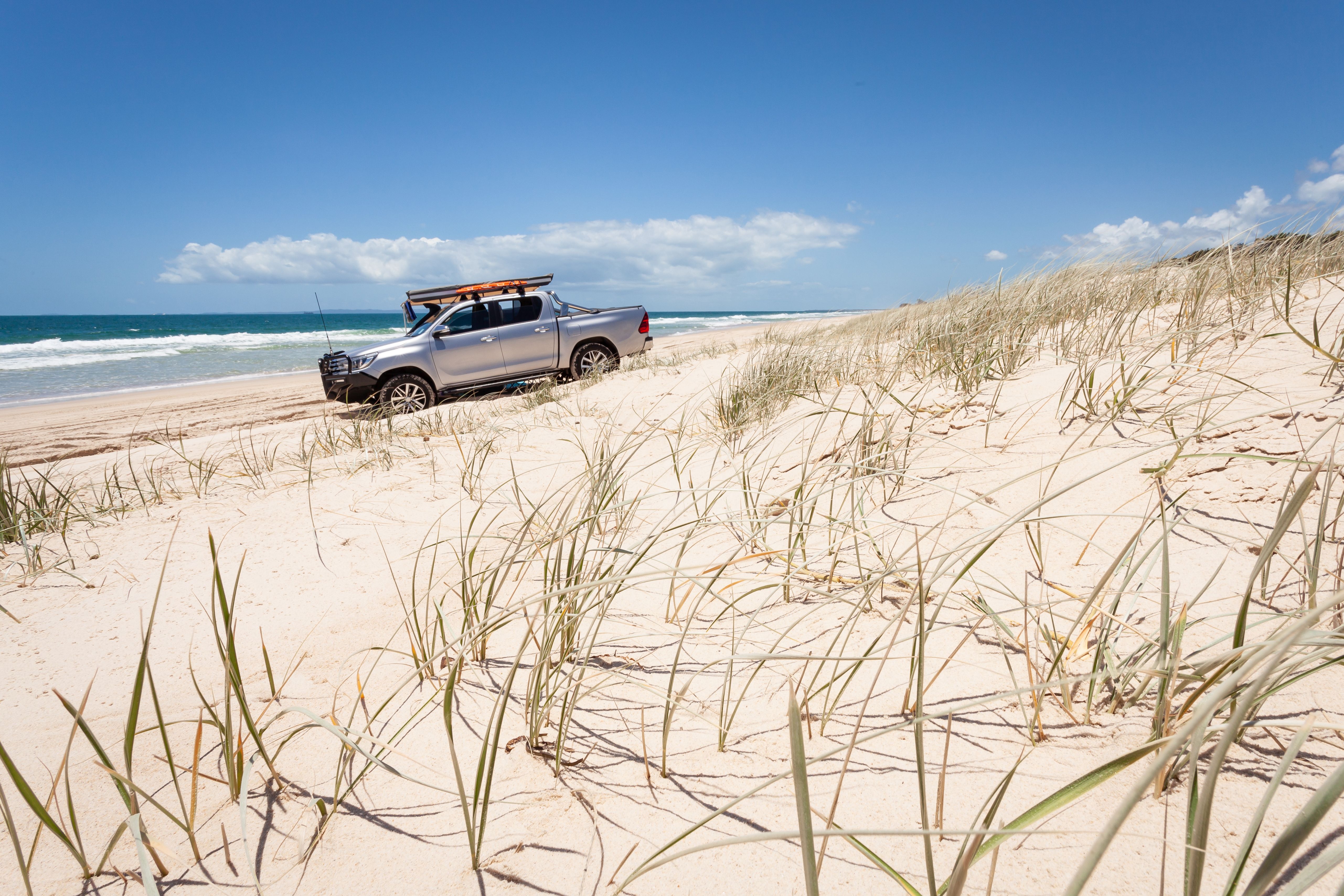A 4X4 ute on a sandy beach