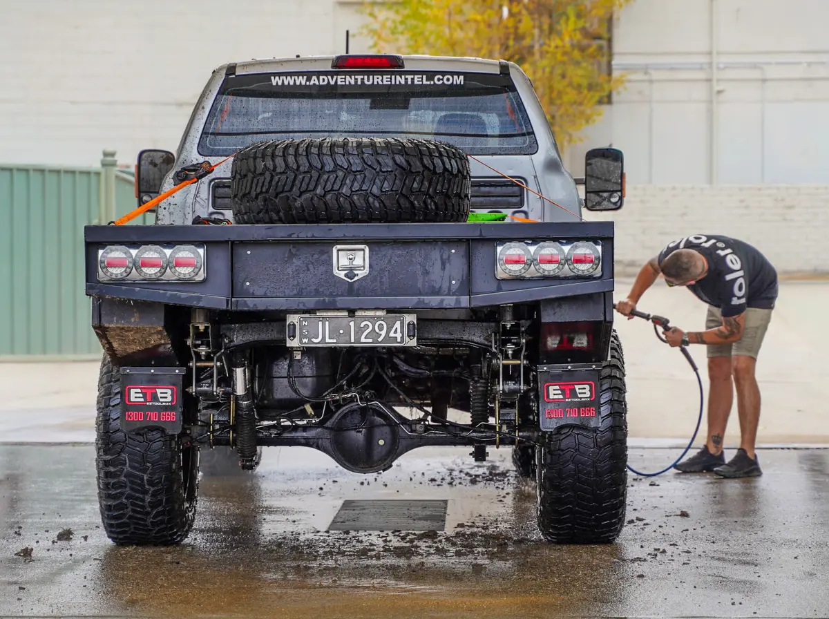 A man cleaning a 4X4 Ford Ranger at a car wash