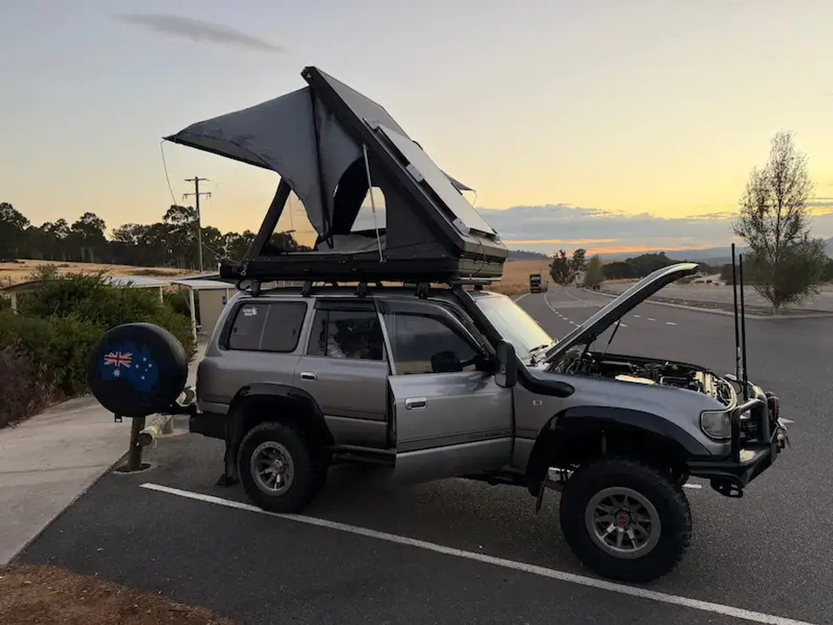 A Toyota LandCruiser 80 Series with rooftop tent