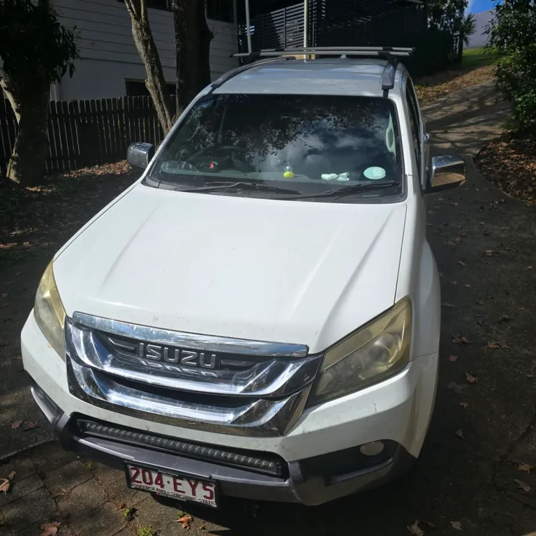 white isuzu MU-X in a driveway