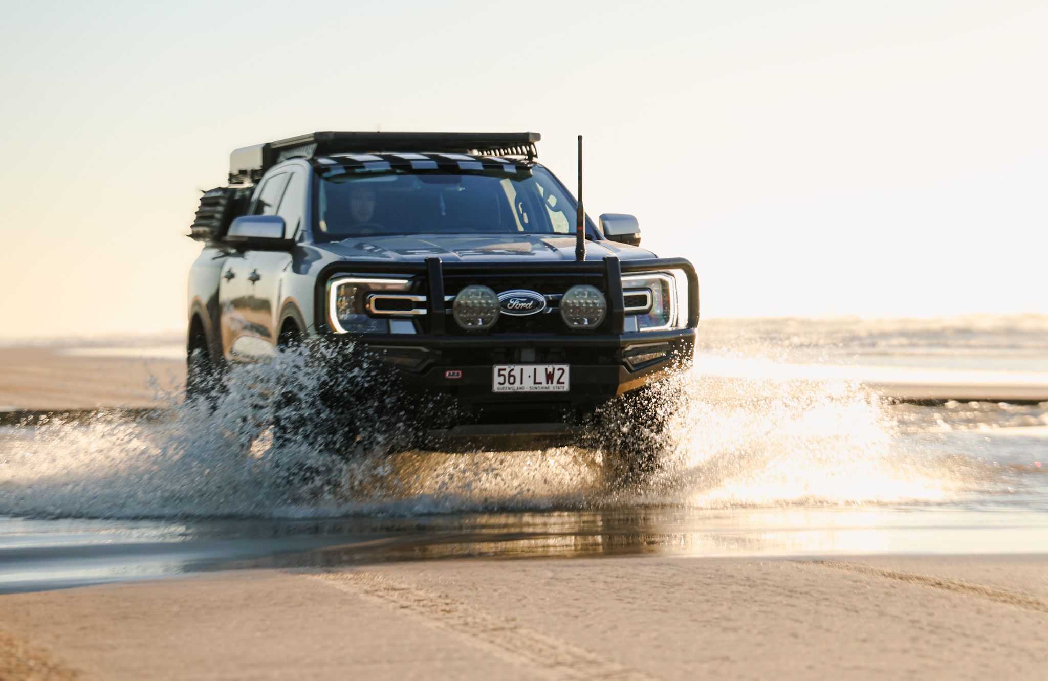 4WD driving through a creek crossing on K'Gari
