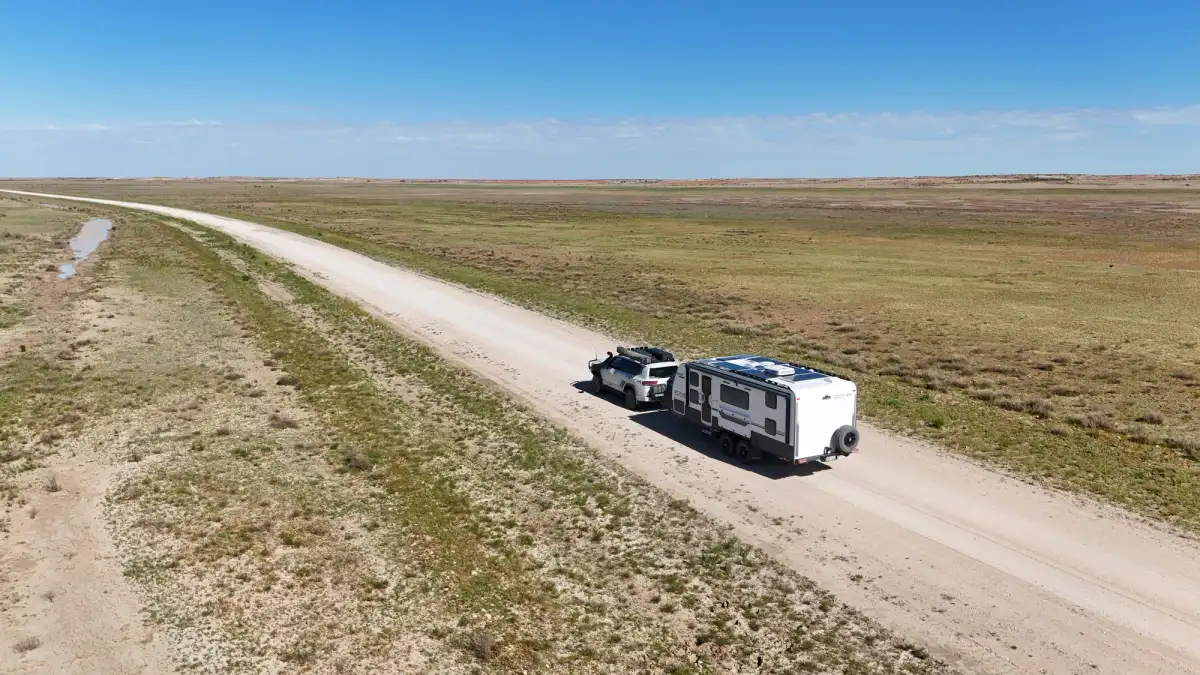 A caravan being towed through the Australian Outback by a 4X4 Toyota LandCruiser