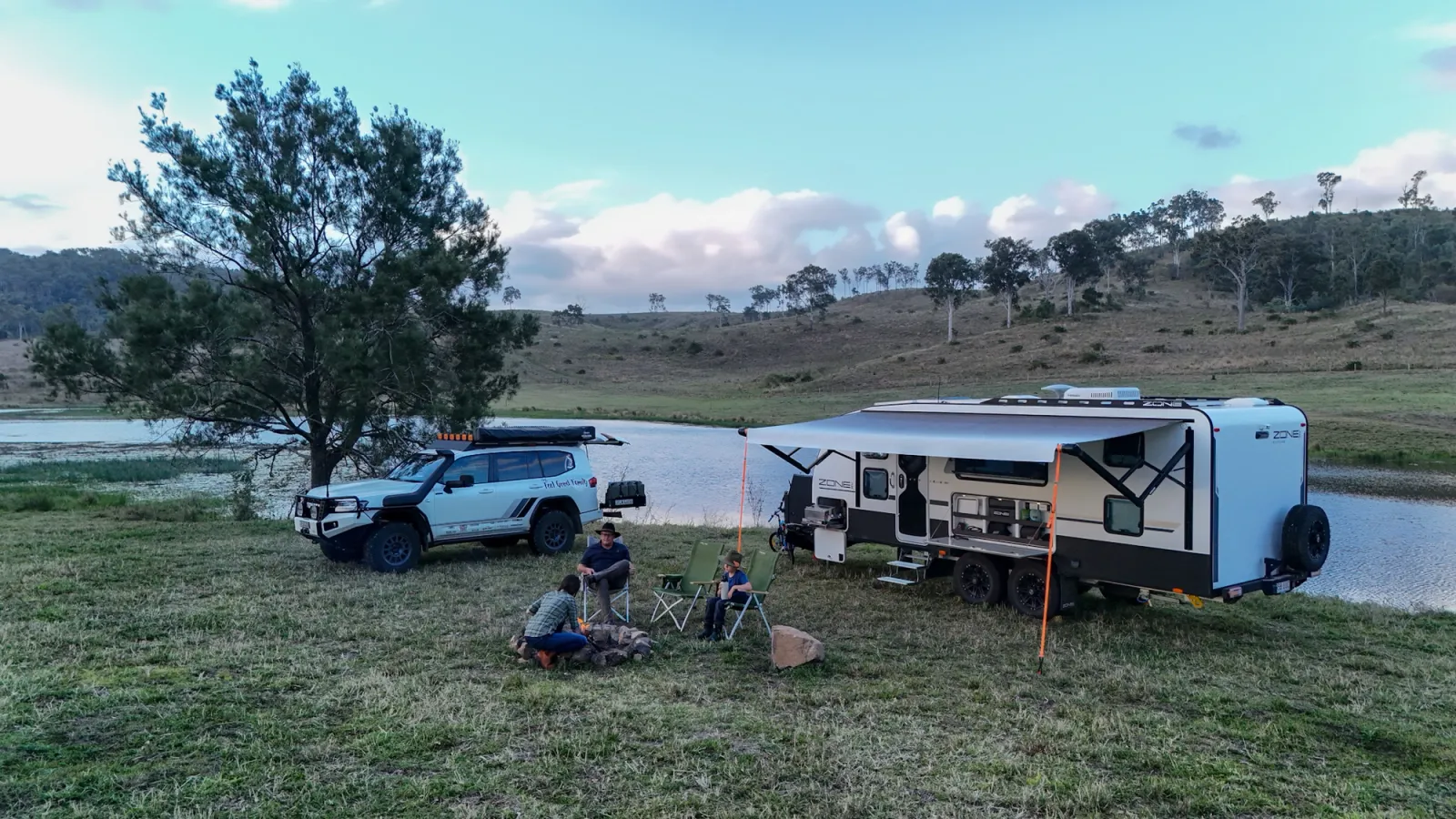 4x4 and caravan at sunset, camped by a lake