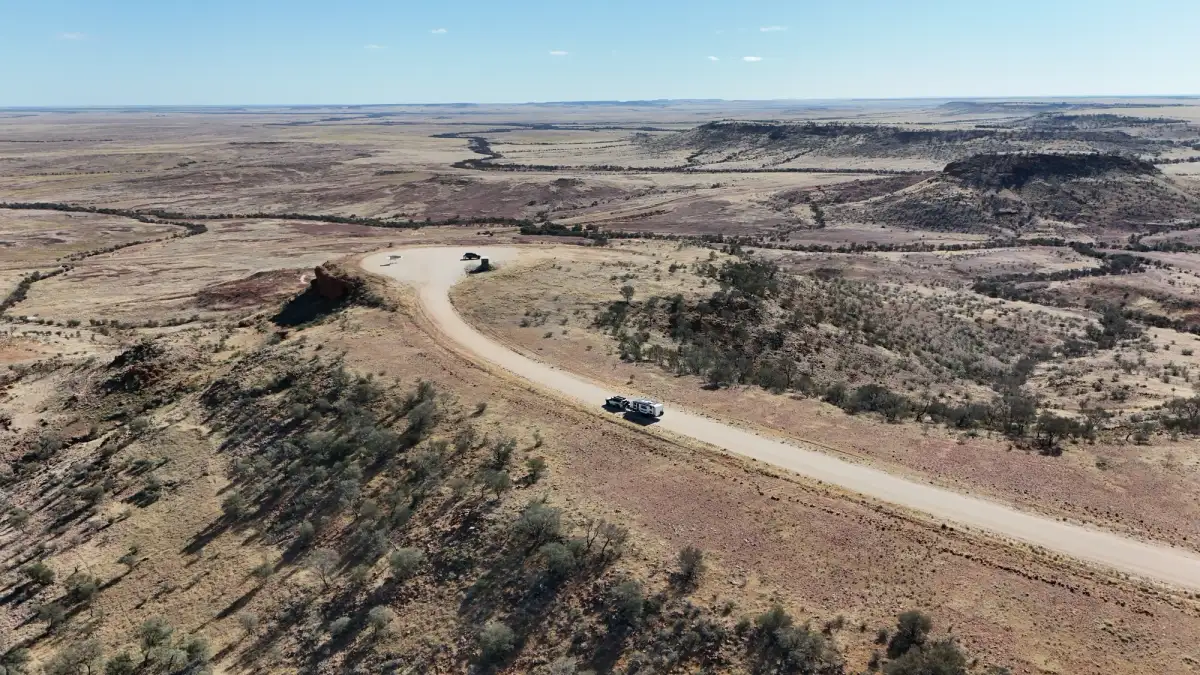 aerial shot of 4wd driving through the outback