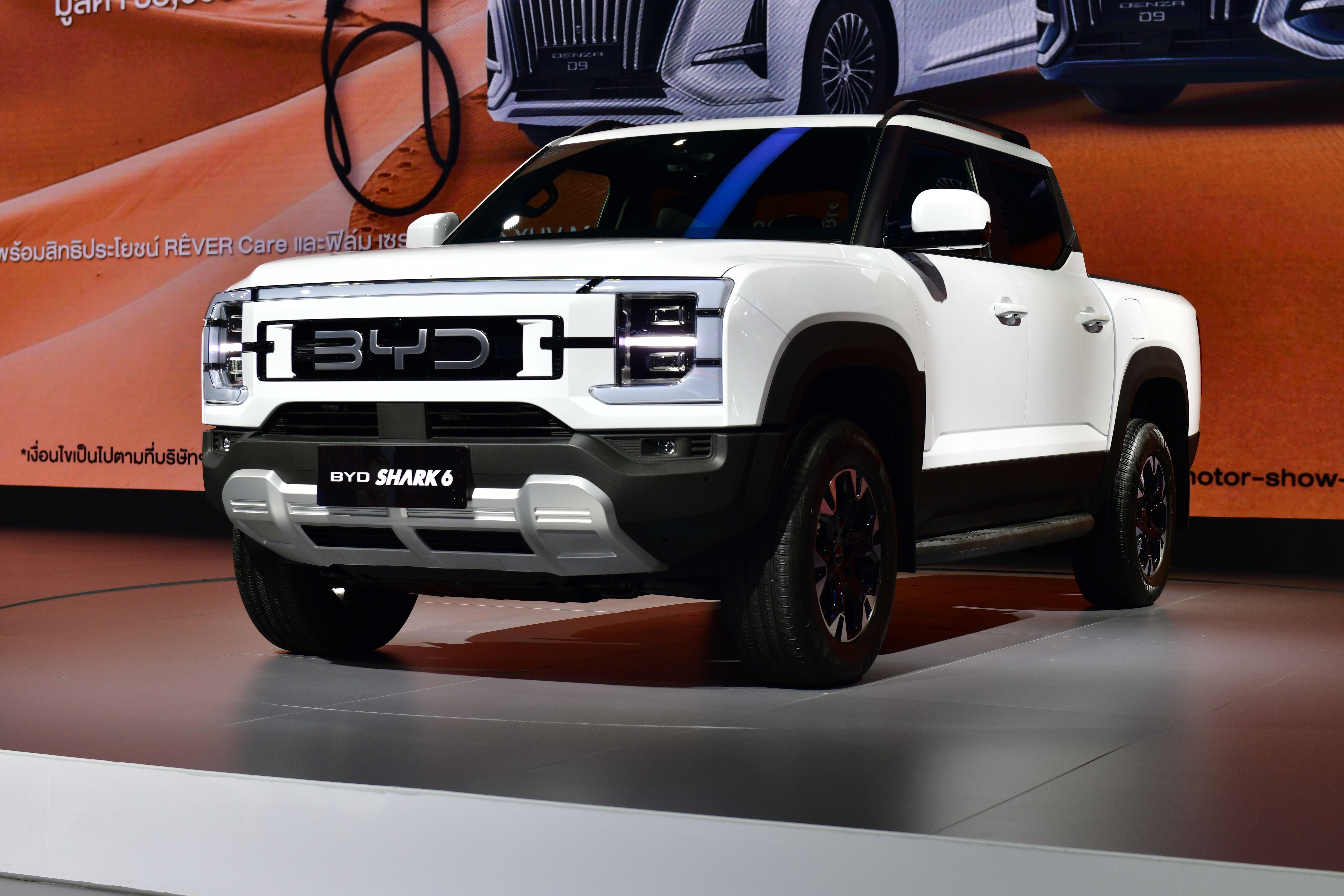 A white BYD Shark 6 in a showroom