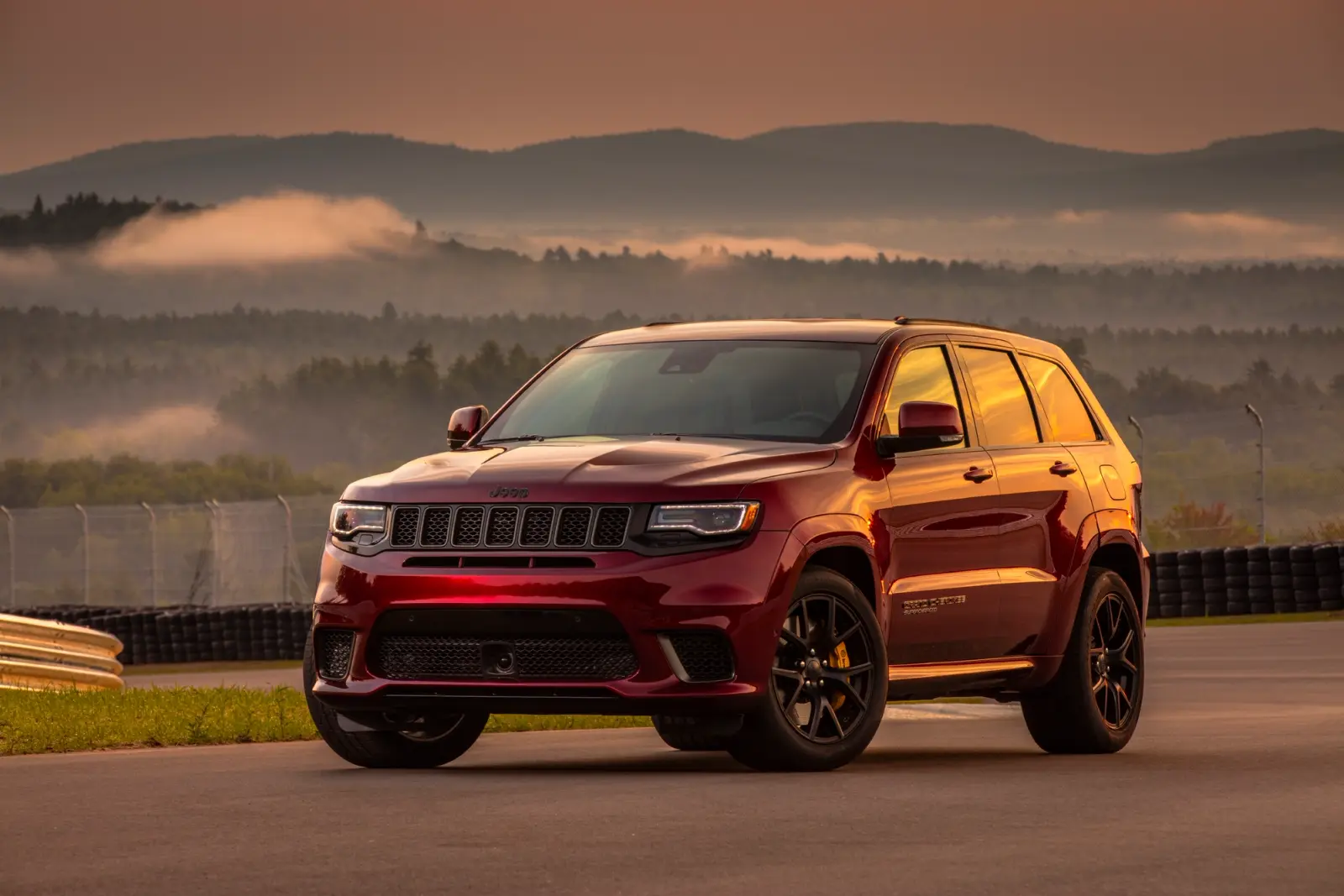 A red Jeep Grand Cherokee Trackhawk during sunset