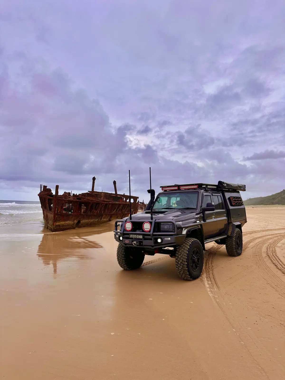 toyota 79 landcruiser with canopy next to maheno