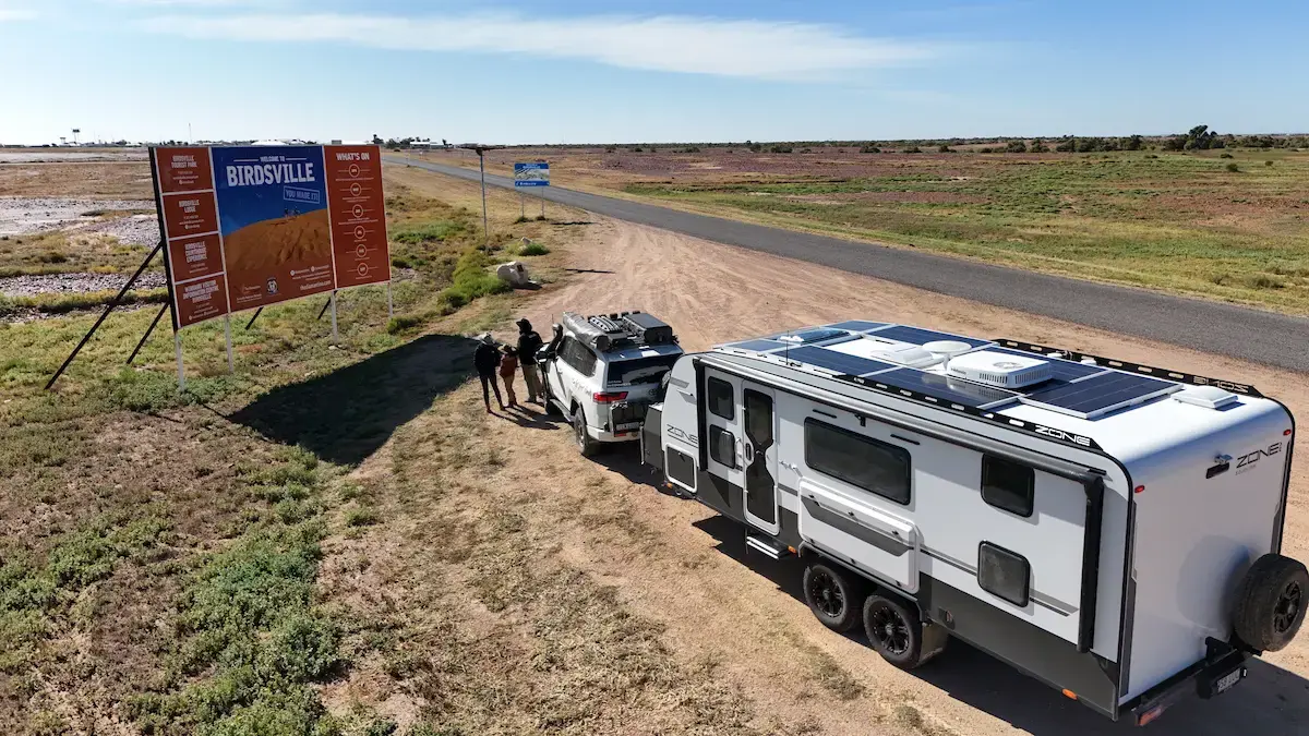 Solar panels mounted on a caravan roof on an Outback road
