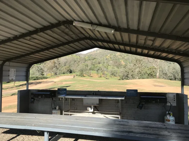 A picture containing building, bench, outdoor, park Description automatically generated