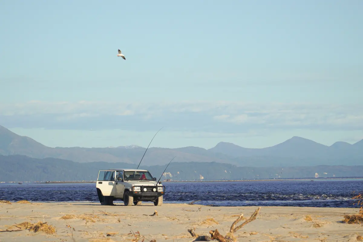 Nissan Patrol with fishing rods on a beach in Tasmania, Australia