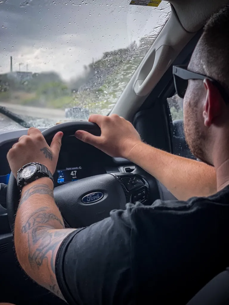 man driving a 4x4 through the rain